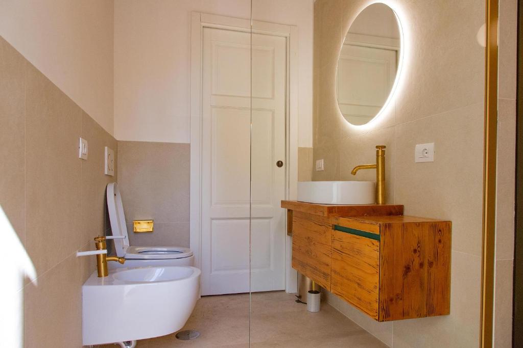 a bathroom with a toilet and a sink and a mirror at Repetita Juvant in Rome