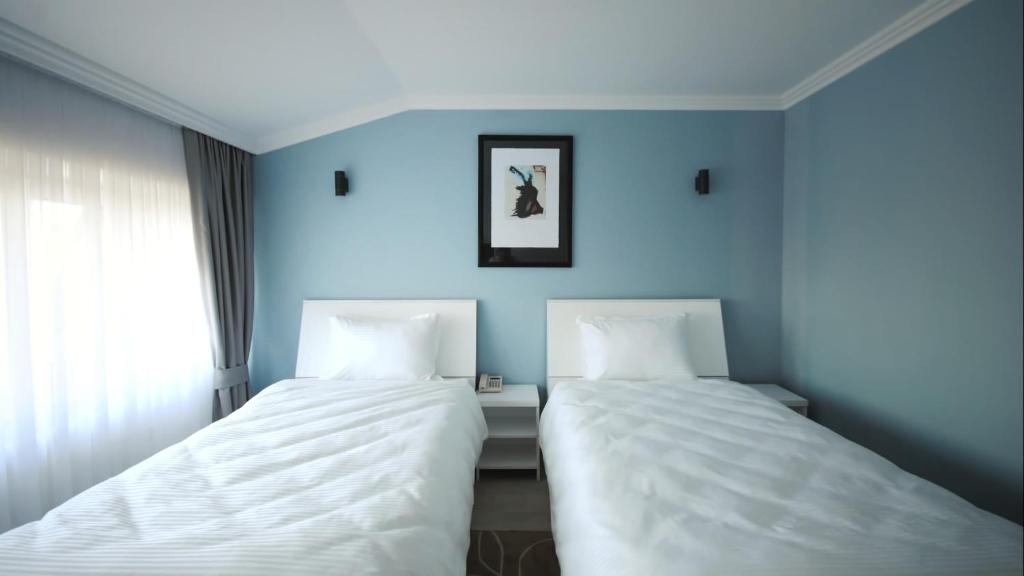 Postel nebo postele na pokoji v ubytování Hotel Callisto