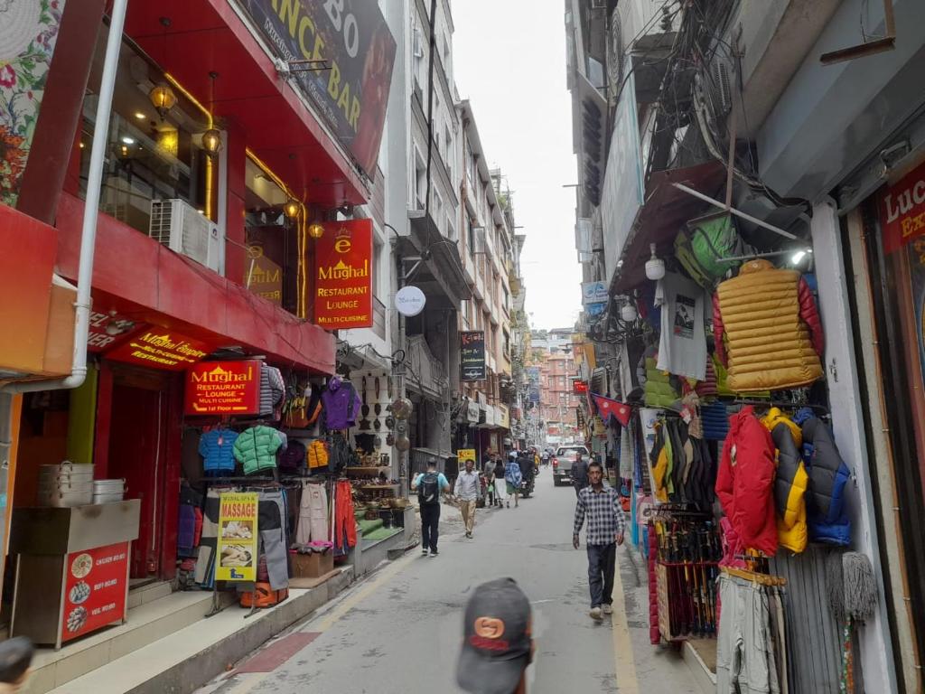 people walking down a street in an alley with shops at Imperial House Thamel - 2 km from Swayambhunath Temple in Kathmandu