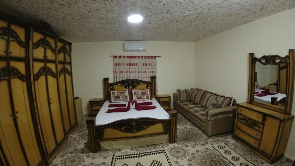 a bedroom with a bed and a couch in a room at Petra Antique House in Wadi Musa