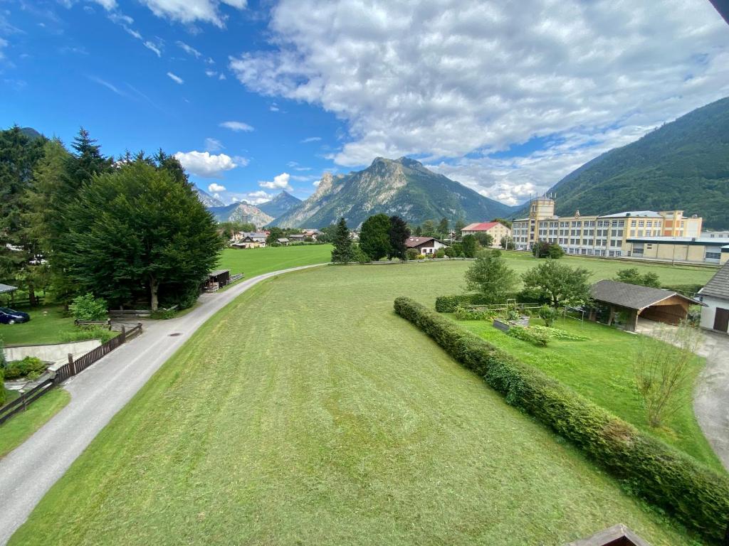 a large grassy field with mountains in the background at Ferienwohnung Stadlmann in Ebensee