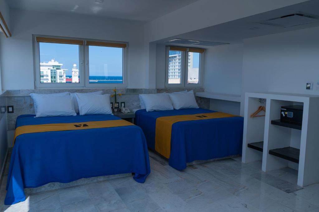 Postel nebo postele na pokoji v ubytování Hawaii Hotel Veracruz