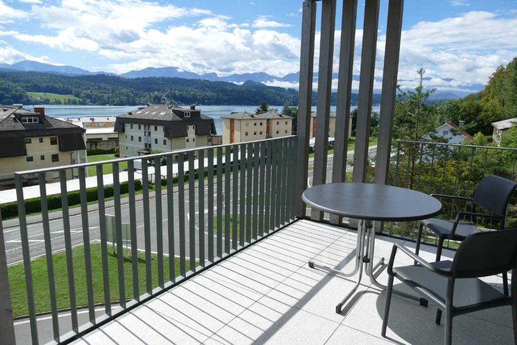 a balcony with a table and chairs and a view at Wörthersee - Apartment 44 in Techelsberg am Worthersee