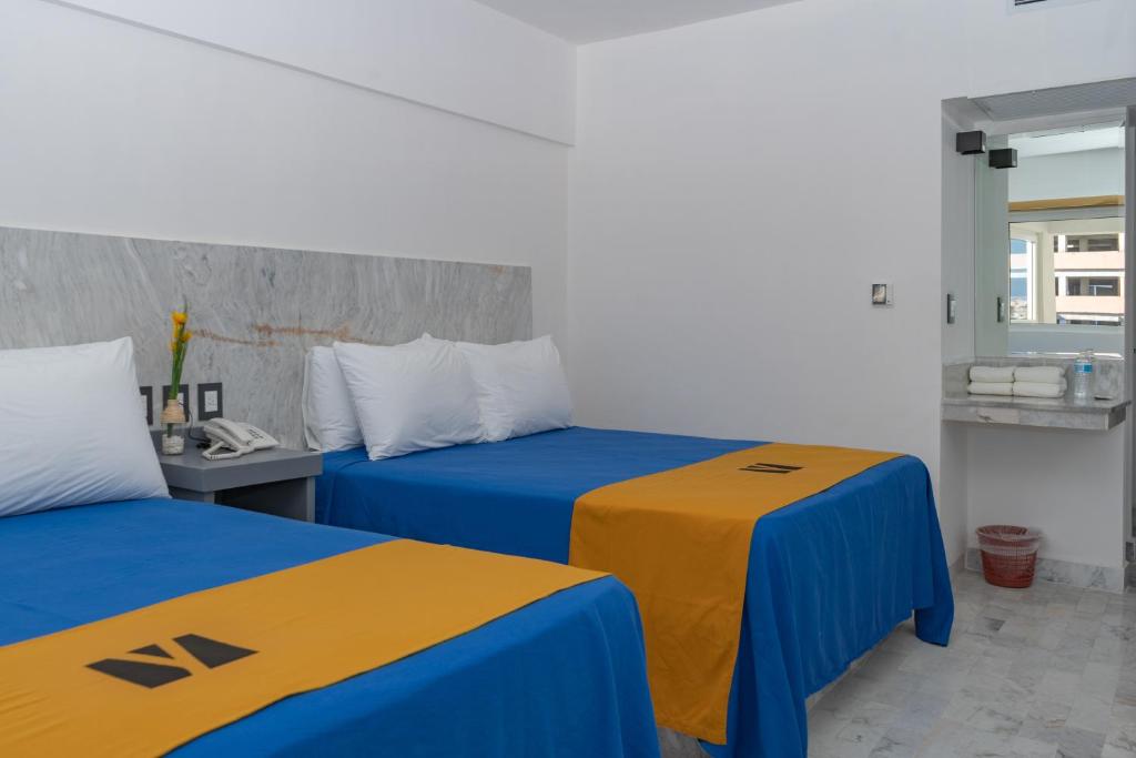 Postel nebo postele na pokoji v ubytování Hawaii Hotel Veracruz