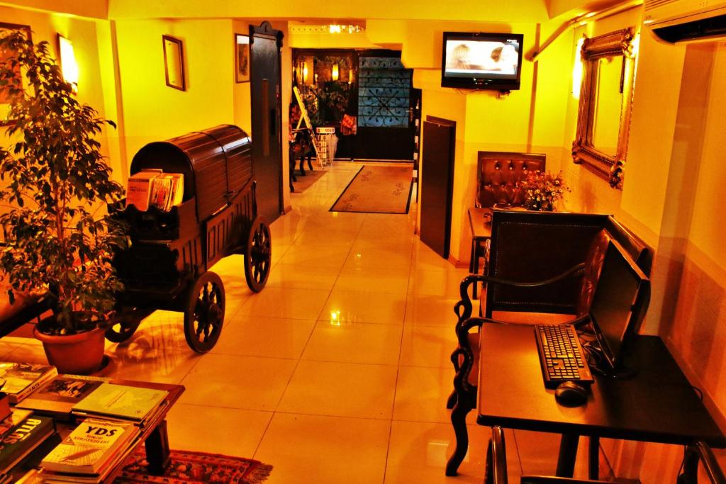 a living room with a chair and a laptop on a table at Sultanahmet Park Hotel in Istanbul