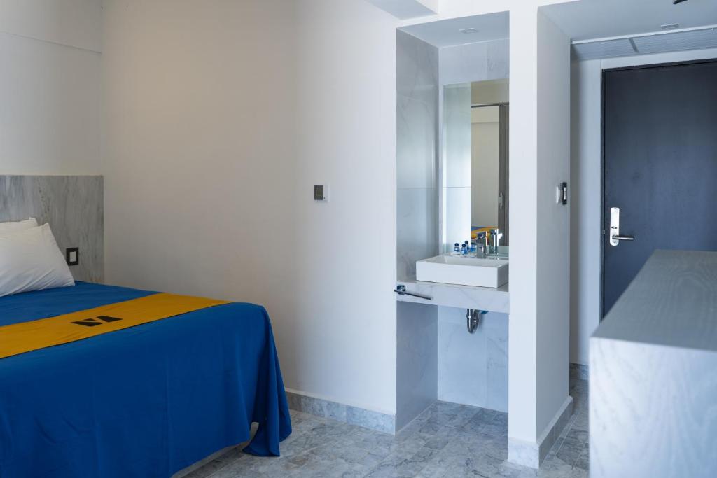 Postel nebo postele na pokoji v ubytování Hawaii Hotel Veracruz