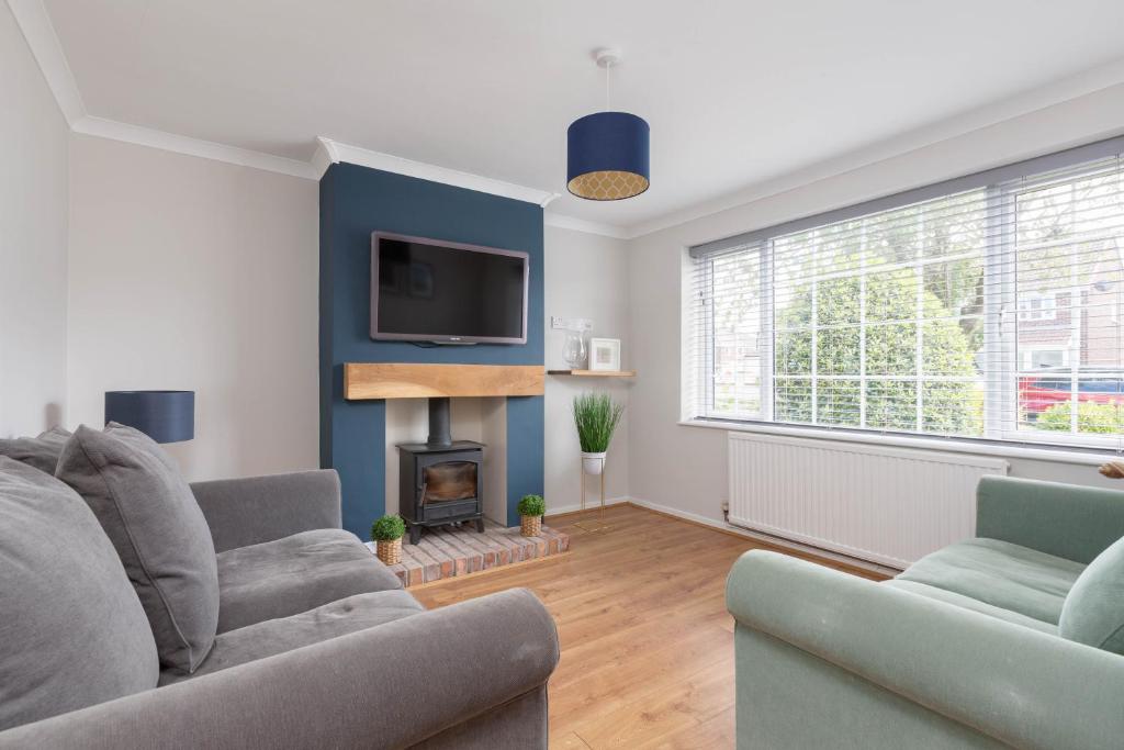 a living room with two couches and a fireplace at Charles Alexander Short Stay - Moorway House in Poulton le Fylde