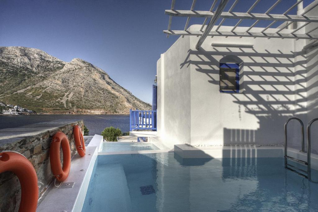 a swimming pool with a view of the mountains at Delfini in Kamarai