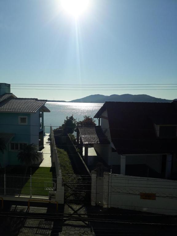 a view of a house and the water at Pousada Vista da Lagoa in Florianópolis
