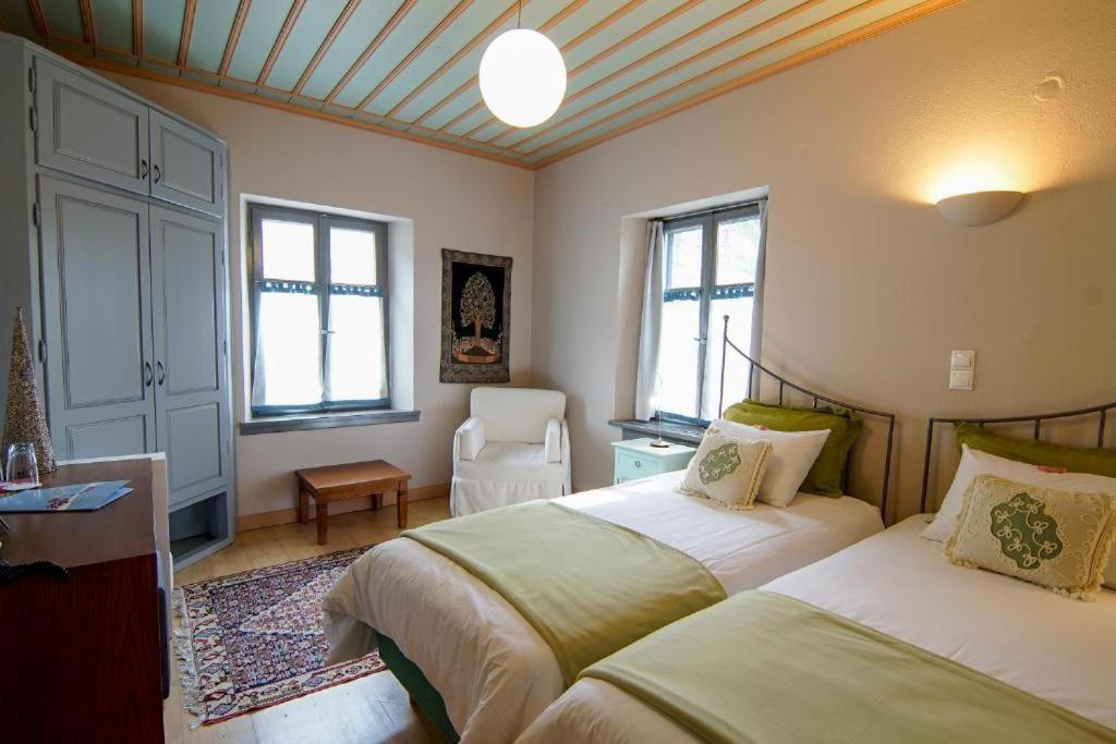 Postel nebo postele na pokoji v ubytování Kyriaki Guesthouse & Suites