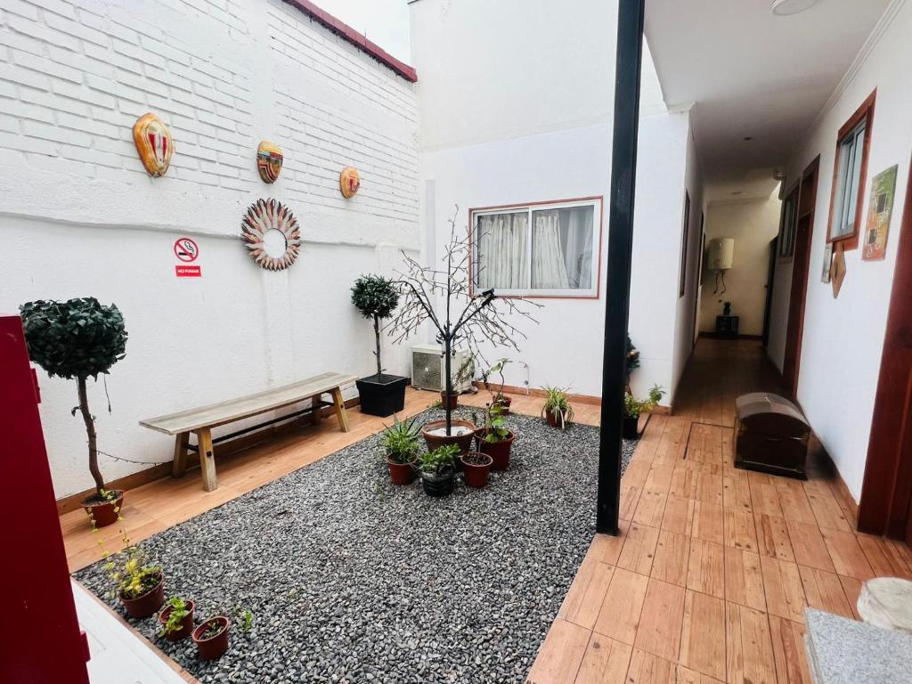 a room with a bench and potted plants at Apartamentos Cerro Blanco in Santiago