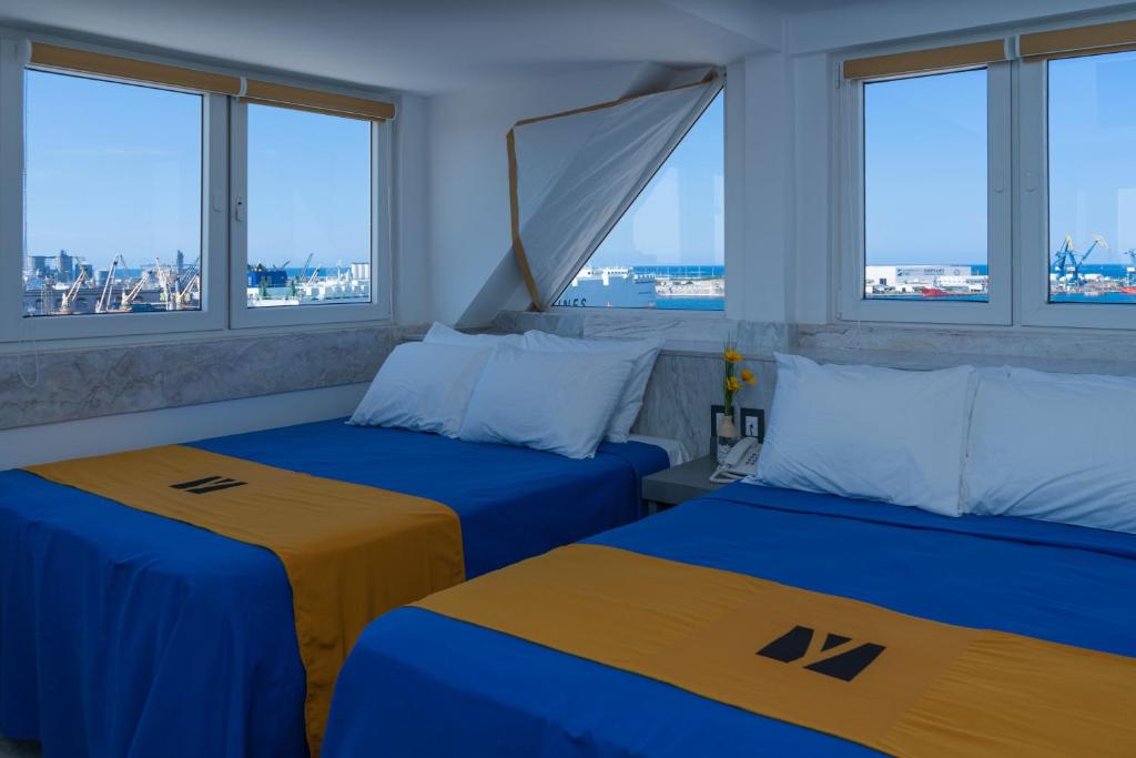 Postel nebo postele na pokoji v ubytování Hawaii Hotel Veracruz