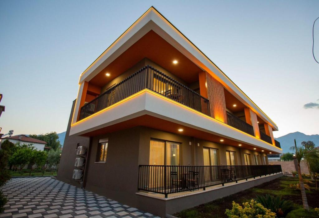 a large house with a balcony on the side of it at Eva Apart Kemer in Kemer