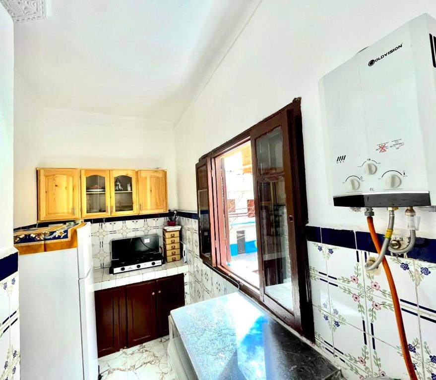 Kuchyň nebo kuchyňský kout v ubytování Appartement Beauté Martil