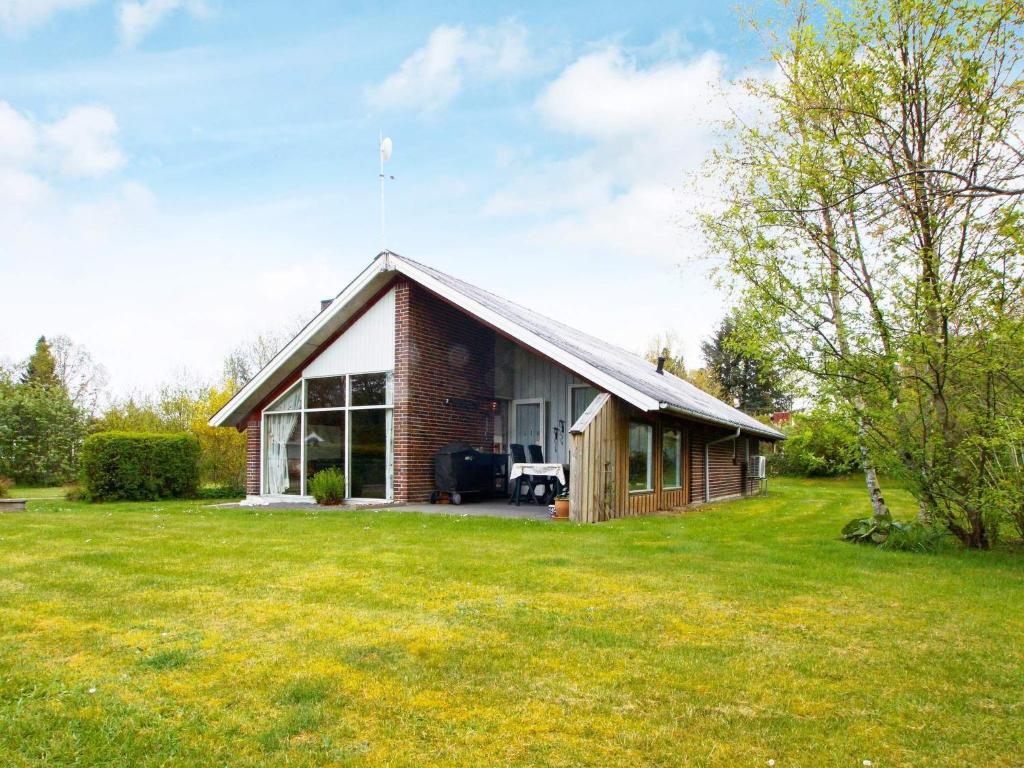 a small brick house with a large yard at 4 person holiday home in Hemmet in Hemmet