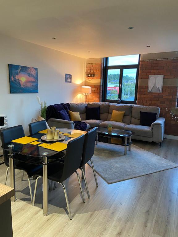 - un salon avec un canapé et une table dans l'établissement Cosy 2 Bed Duplex City Apartment, à Bradford