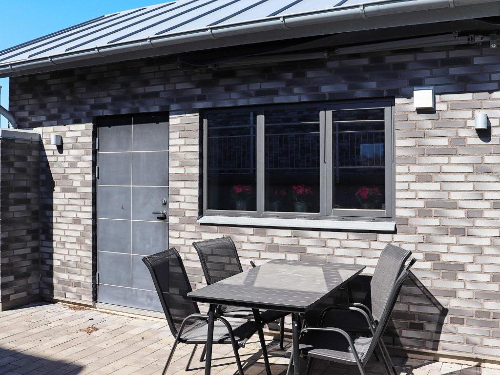 a table and chairs in front of a garage at 2 person holiday home in VARBERG-By Traum in Varberg