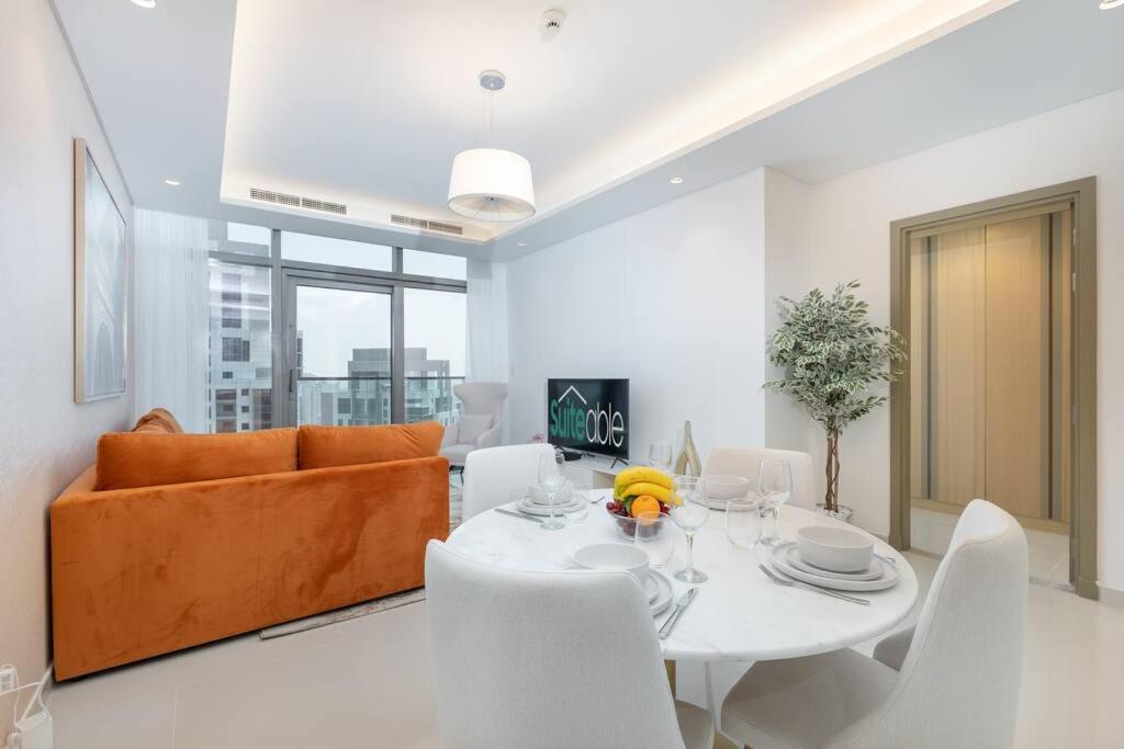 a living room with a table and a couch at Opulent Hollywood Styled Flat in Paramount Tower in Dubai