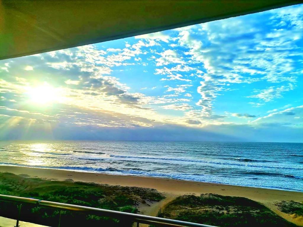 a view of the ocean from a balcony at Beachside 3 bed apartment with stunning seaviews in Amanzimtoti