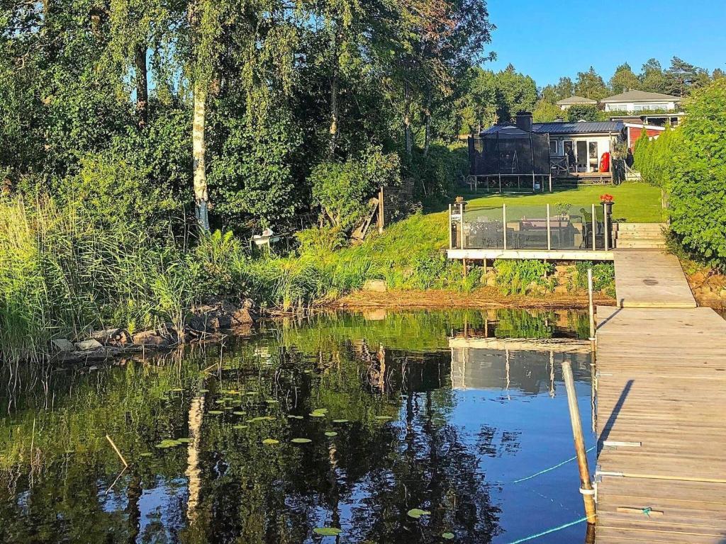 a body of water with a dock and a house at 6 person holiday home in N SSJ in Nässjö