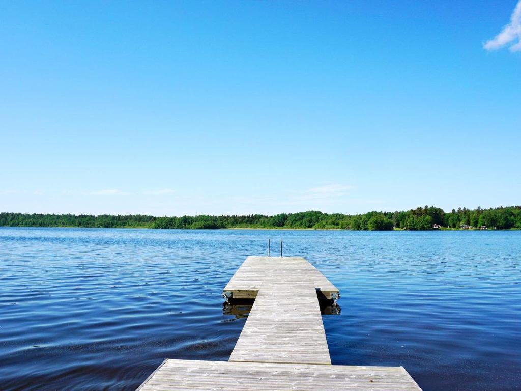 a wooden dock in the middle of a lake at Holiday home RIMBO II in Rimbo