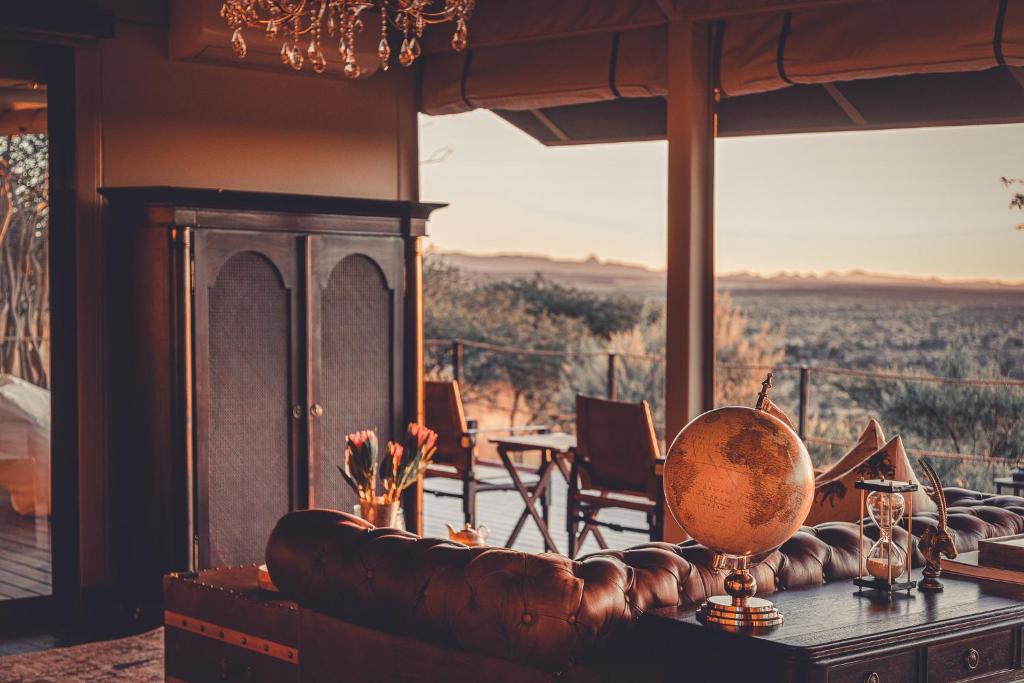 a room with a couch and a table with a view at Gmundner Lodge in Windhoek