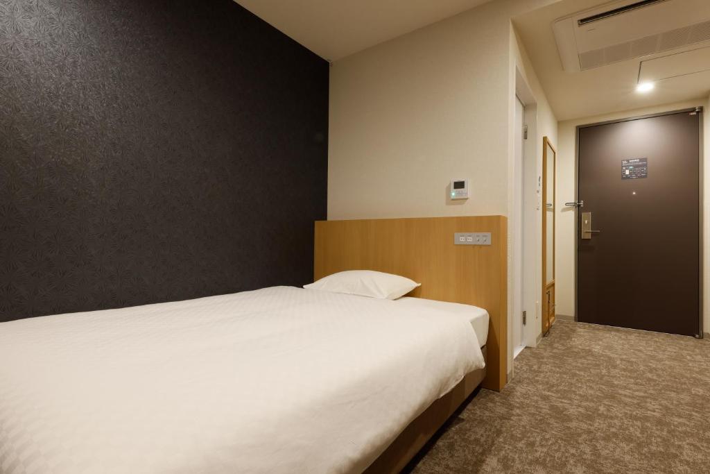 Postel nebo postele na pokoji v ubytování Plum Hotel