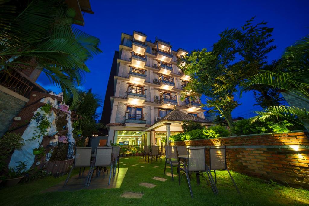 a hotel at night with chairs in front of it at Kumari Star Inn in Pokhara