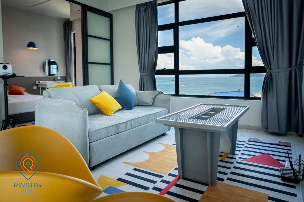 a living room with a couch and a table at Jesselton Quay by Pinstay in Kota Kinabalu