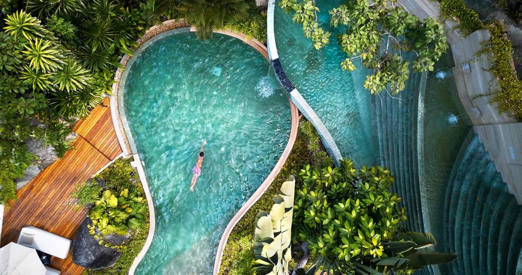 an overhead view of a swimming pool with a person in it at The Spa Resorts - Lamai Village in Amphoe Koksamui
