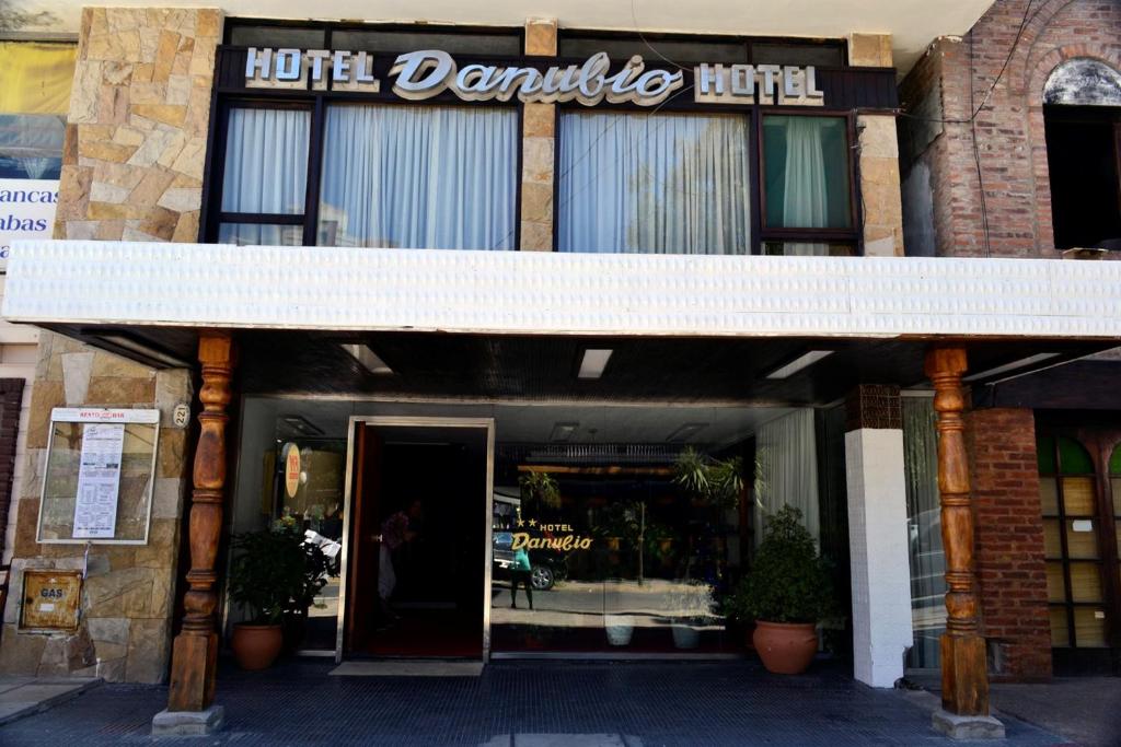 a store front of a building with a sign on it at Hotel Danubio in Villa Gesell