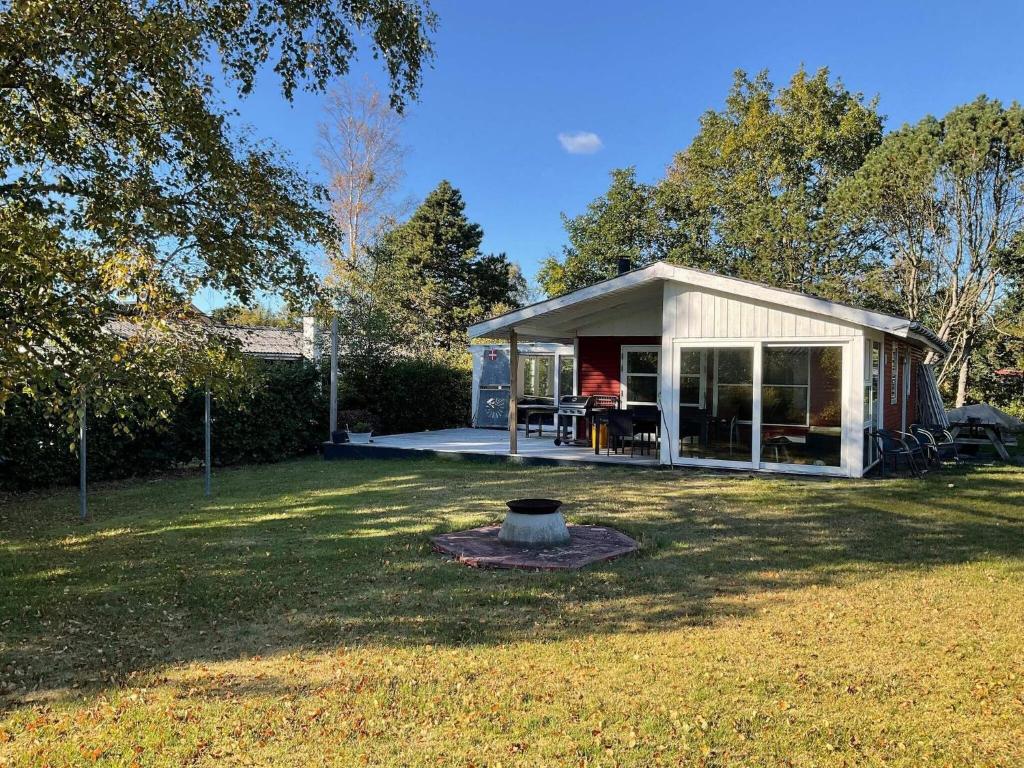 a small white shed in a yard at 4 person holiday home in Hals-By Traum in Hals