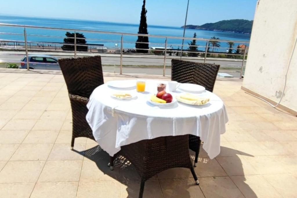 a table with food on it with a view of the ocean at Seaview, just across the beach, Bečići in Bečići