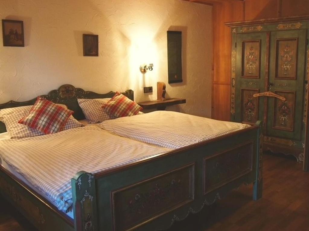 a bedroom with a large bed in a room at Gästehaus am Eichbach in Schramberg
