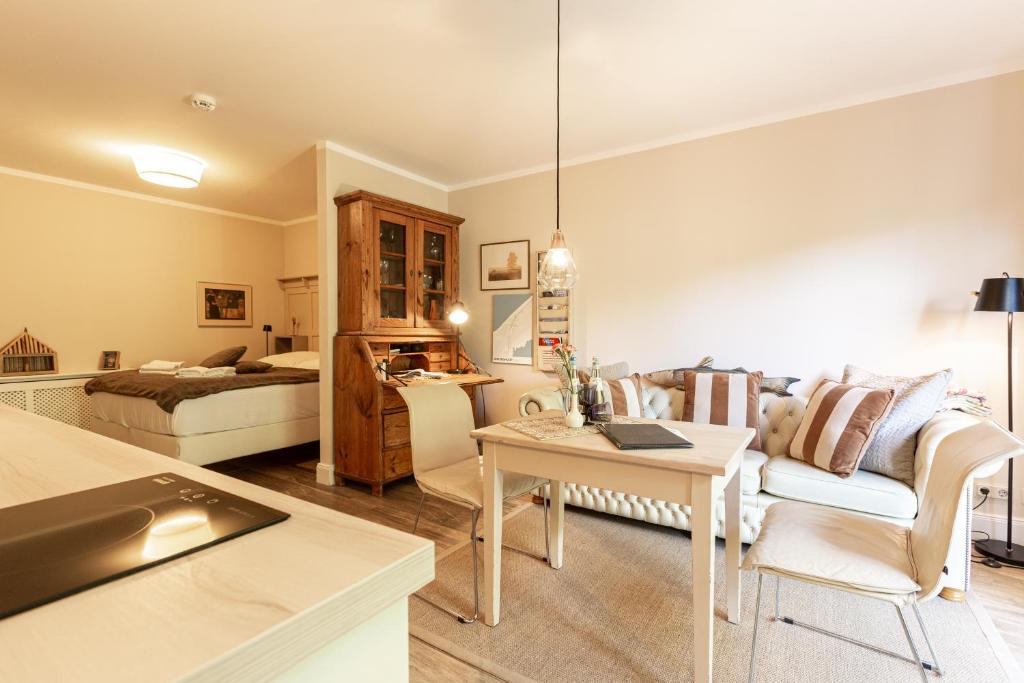 a living room with a couch and a bed at Christian in Ahrenshoop