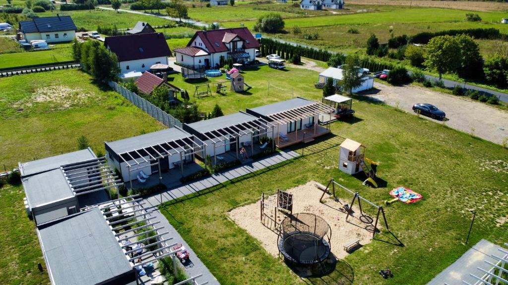 an aerial view of a train station with a train on a field at Resto domki letniskowe in Sarbinowo