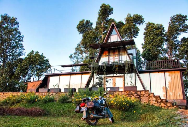 a motorcycle parked in front of a house at The Backyard Balangoda in Balangoda