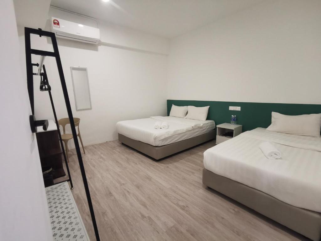 Postel nebo postele na pokoji v ubytování Perfect Hub Semporna