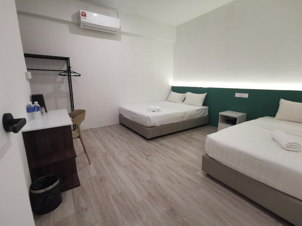 Postel nebo postele na pokoji v ubytování Perfect Hub Semporna