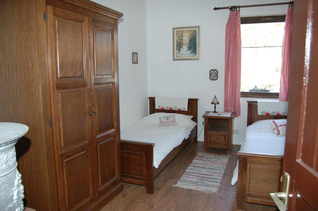 a small bedroom with two beds and a window at Apartment at Agroturizam OPG Kovacevic in Daruvar