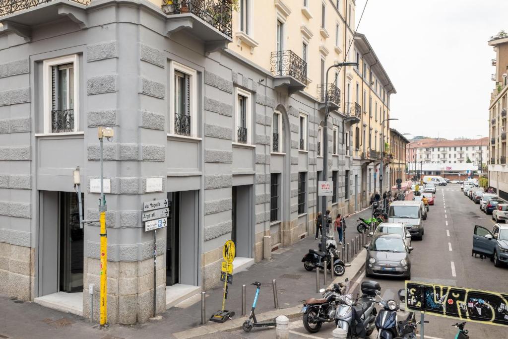 budynek na ulicy z samochodami zaparkowanymi na ulicy w obiekcie Ripa Apartments Milano - Ripa 57 w Mediolanie