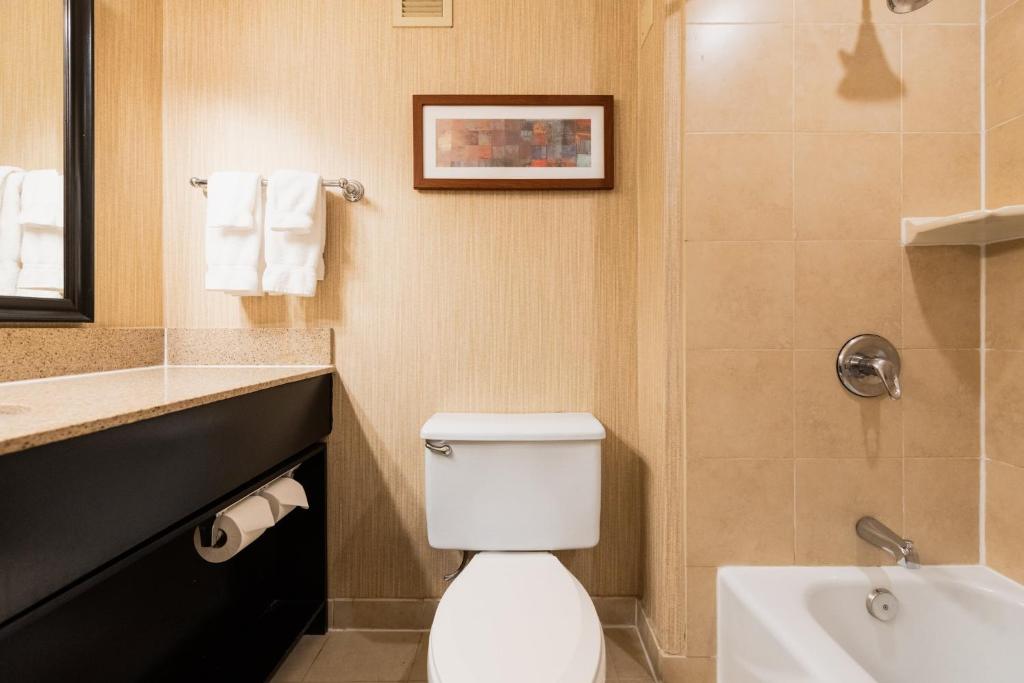 a bathroom with a toilet and a sink at Crowne Plaza Newark Airport by IHG in Elizabeth