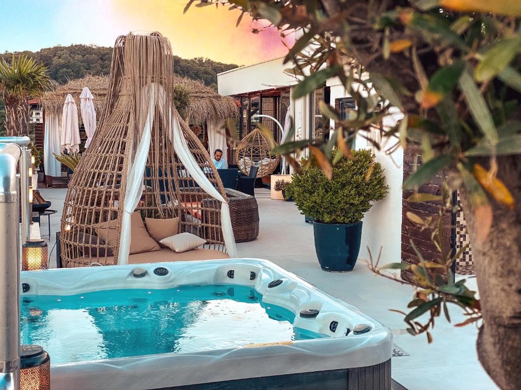 a hot tub on a patio with a hammock at RESIDENCE Apartments in Ulcinj