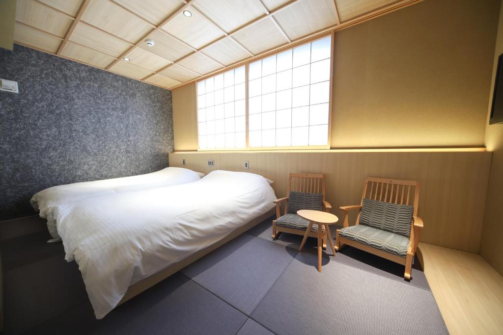 Postel nebo postele na pokoji v ubytování 利々 京都 lili hotel kyoto