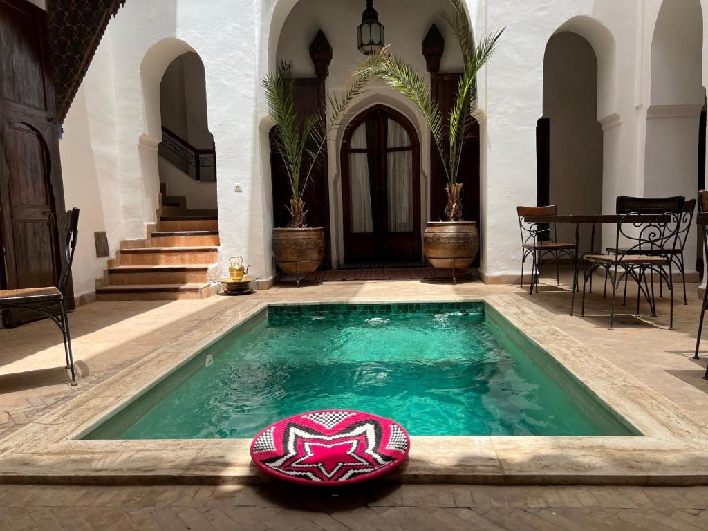 a swimming pool in the middle of a house at Riad Nora in Marrakesh