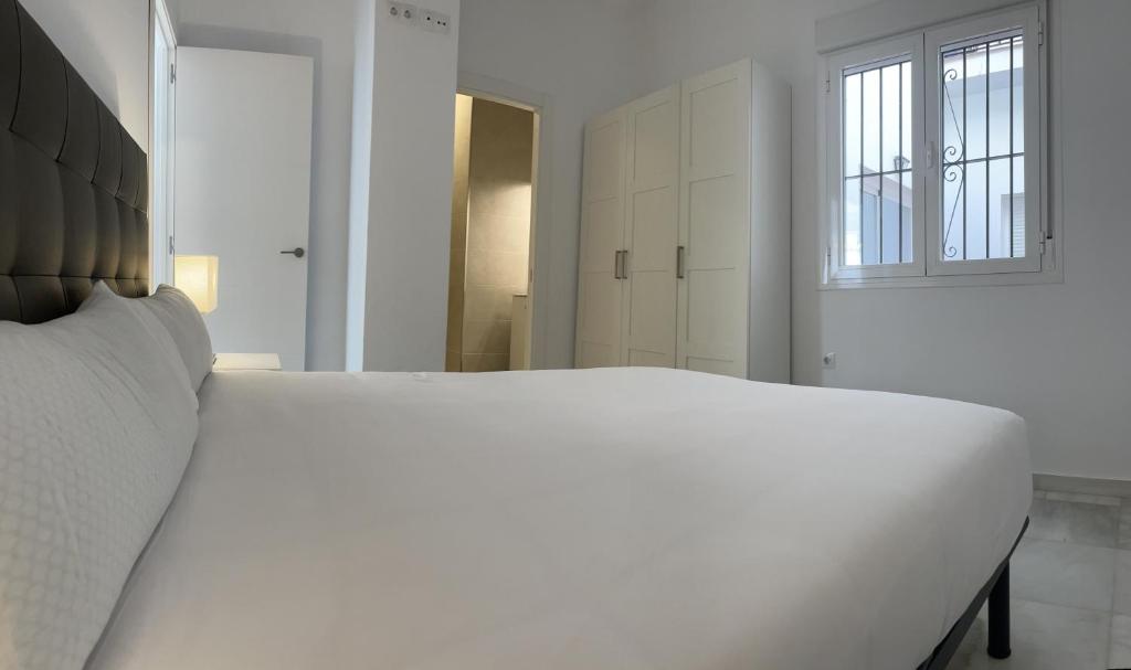Posteľ alebo postele v izbe v ubytovaní Apartamentos Registro Ronda Centro