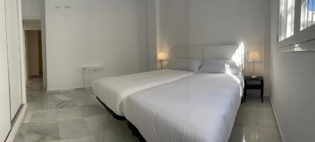 Posteľ alebo postele v izbe v ubytovaní Apartamentos Registro Ronda Centro