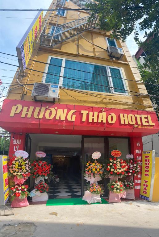 a philong thanh hotel with flowers in front of it at Phương Thảo Hotel in Hanoi