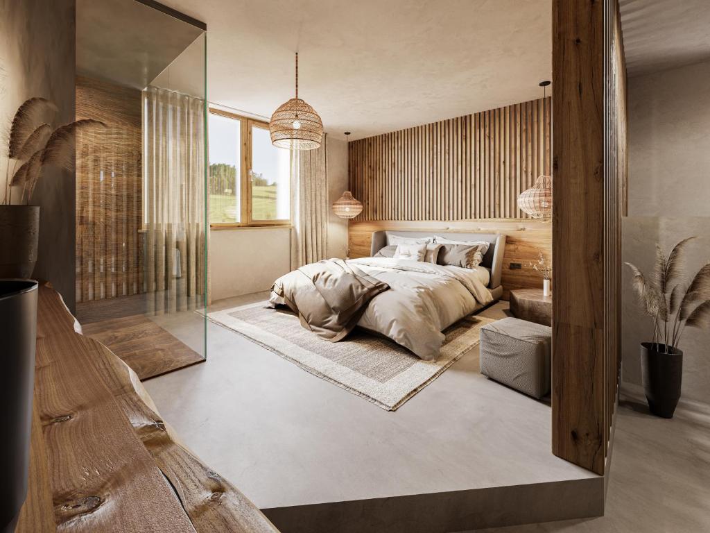a bedroom with a large bed and a large mirror at 4Monkeys Apartments in Balderschwang