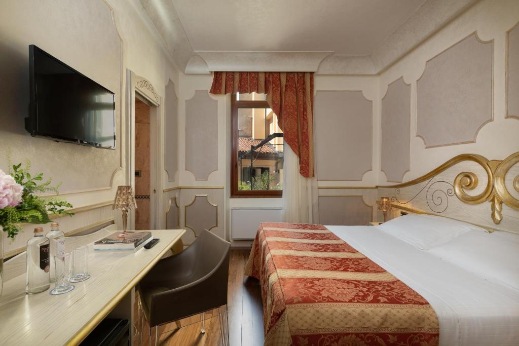 Postel nebo postele na pokoji v ubytování Hotel Colomba d'Oro